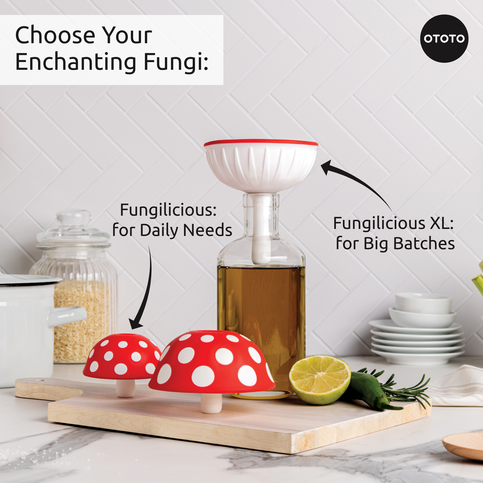 Two red-and-white OTOTO Fungilicious foldable kitchen funnels sit near a bottle and chopped lime.