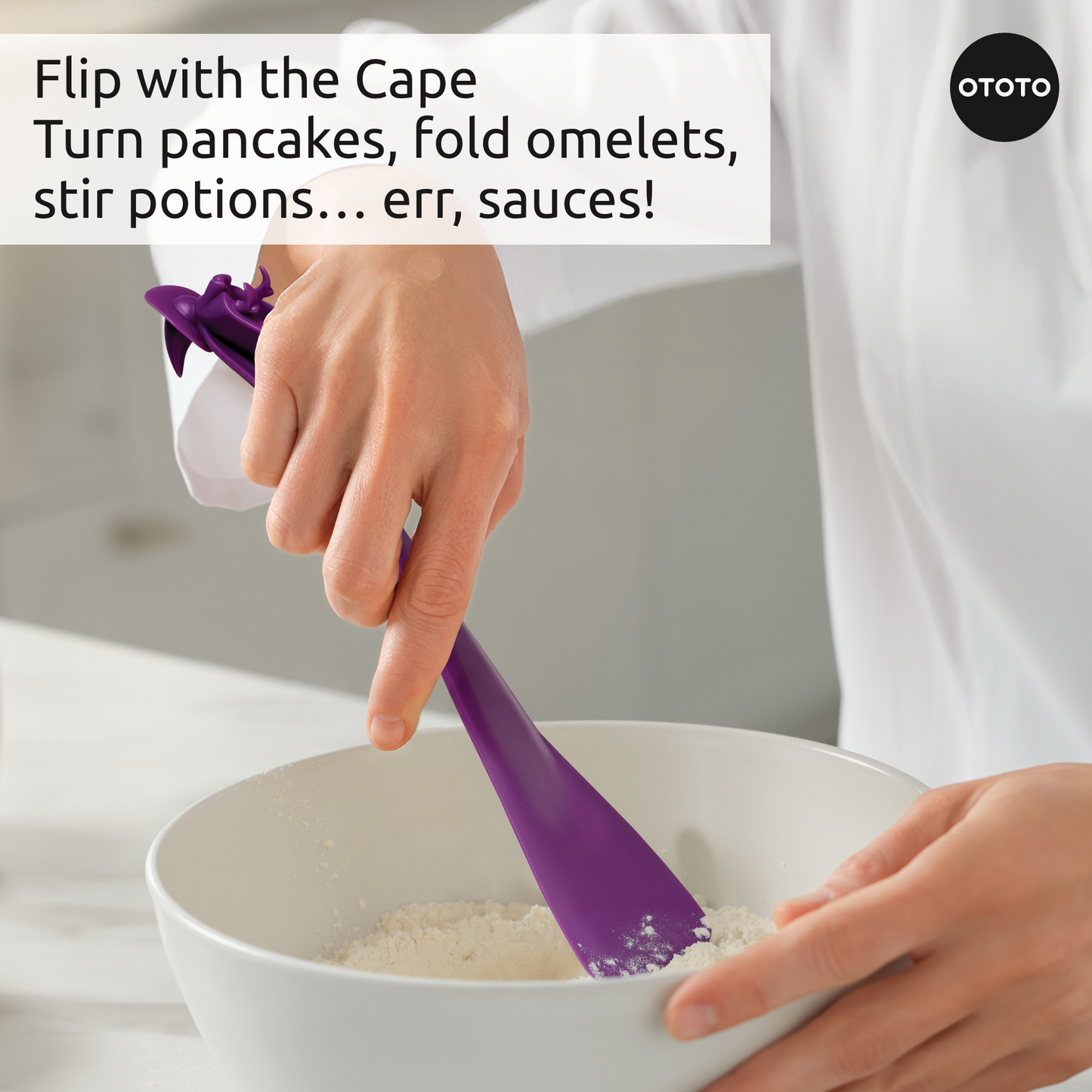 A person stirs batter in a bowl with the Witchin heat-resistant purple silicone cape spatula.