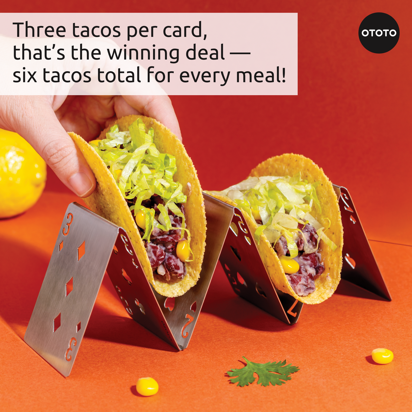 Two Pick-a-Taco holders, each holding three tacos with lettuce and corn, on an orange surface.