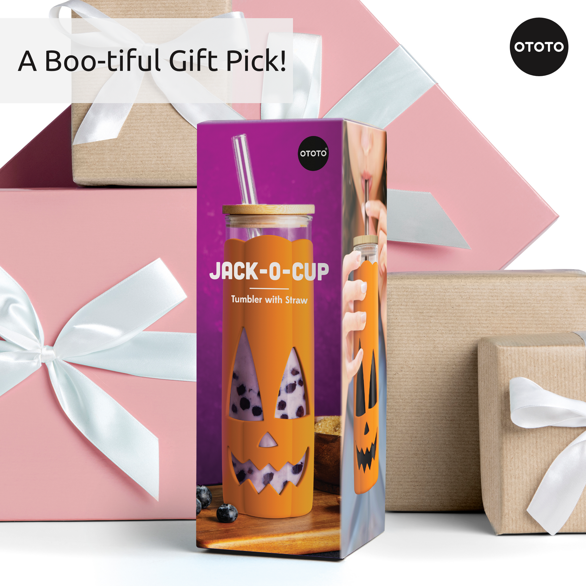 Boxed Jack-o-Cup with straw sits in front of pink and brown gifts wrapped with white ribbons.