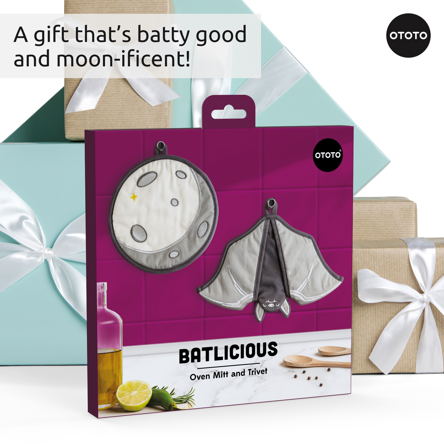 Batlicious gift box with gothic bat and moon oven mitts; wrapped presents shown behind.
