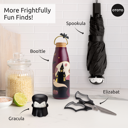 A Halloween kitchen with bat scissors, OTOTO vampire bottle stopper, and Boo!tle ghost bottle.