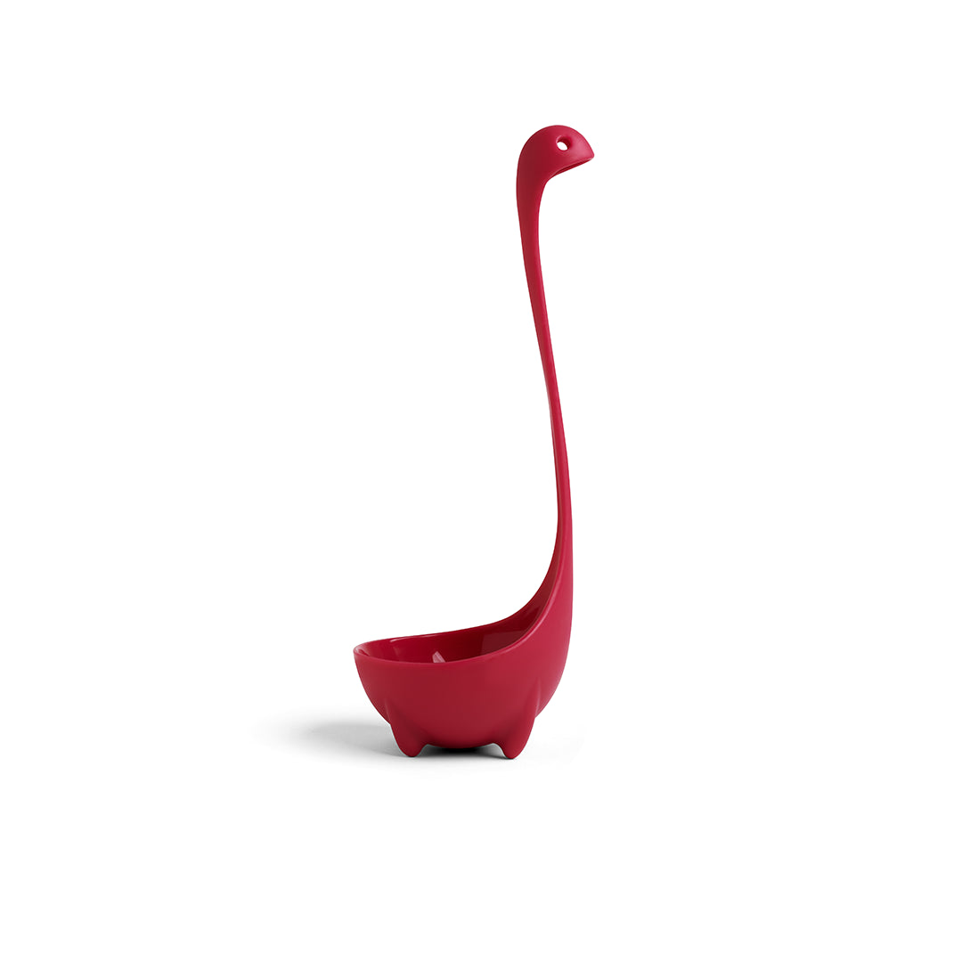 Jumbo Nessie soup ladle, shaped like a red dinosaur, stands upright on a white background.