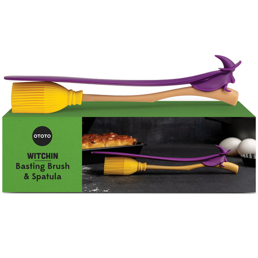 The Witchin set includes a broomstick-shaped basting brush and heat-resistant spatula in a green box.