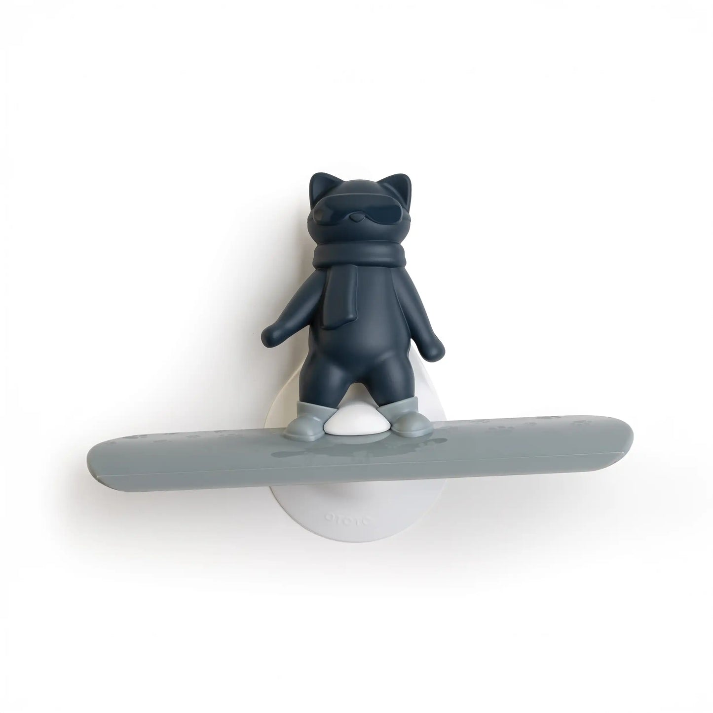 A dark gray Chill Cat with sunglasses stands on a snowboard, mounted on a white base.