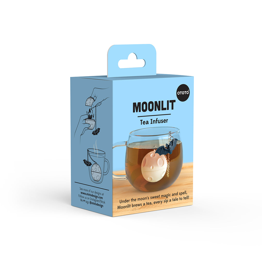 The Moonlit Tea Infuser by OTOTO floats in your cup like a moon against a blue background.