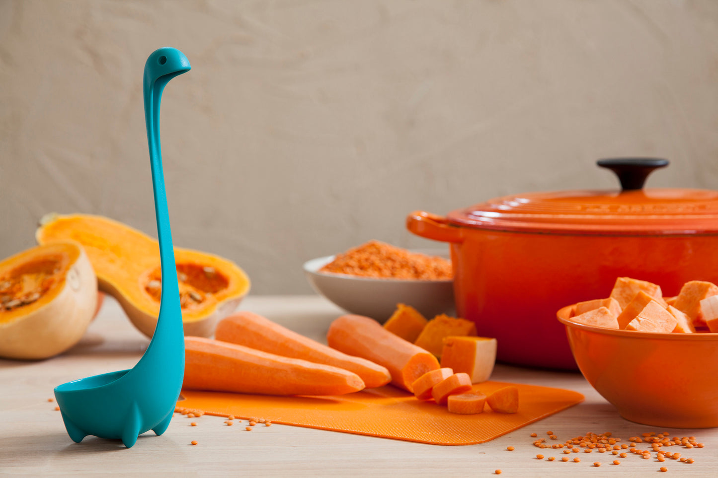 Nessie stands by chopped sweet potatoes, lentils, and an orange OTOTO pot.