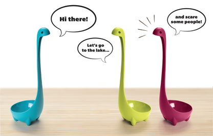 Three colorful Nessie ladles chat with speech bubbles on a wooden surface.