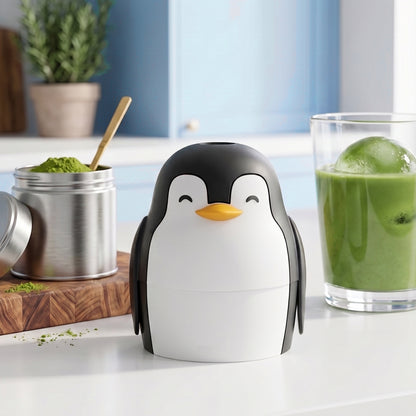 Penny the penguin ice mold sits on your counter, ready to craft slow-melting round ice spheres.