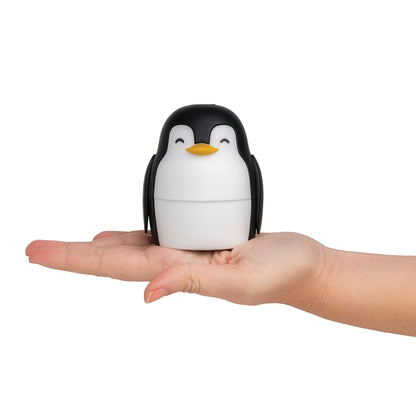 A hand holds Penny, an ice mold perfect for making slow-melting, round ice spheres, on white.