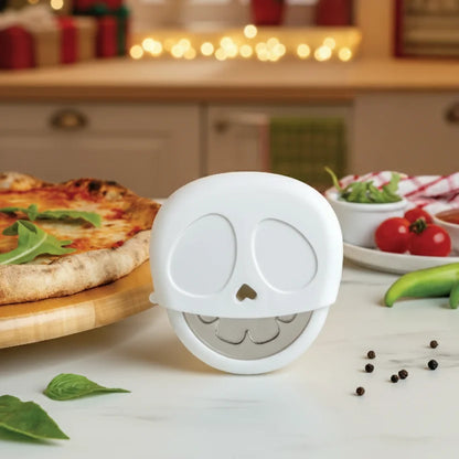 The Slice Reaper pizza cutter by OTOTO stands on a kitchen counter beside a pizza and fresh toppings.