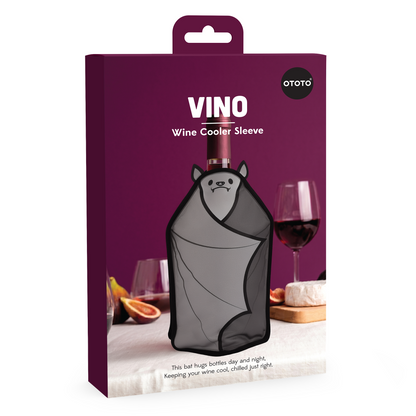 A Vino bat-shaped wine cooler sleeve chills a bottle, glasses, and figs on a purple backdrop.