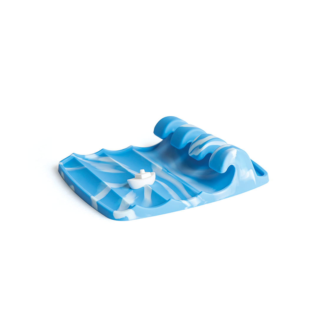The Wavy is a blue plastic wave sculpture with a small white boat, perfect for OTOTO-inspired countertops.