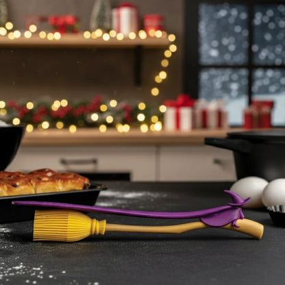 Witchin: Two heat resistant kitchen utensils shaped like a broom and wand on a festive counter.