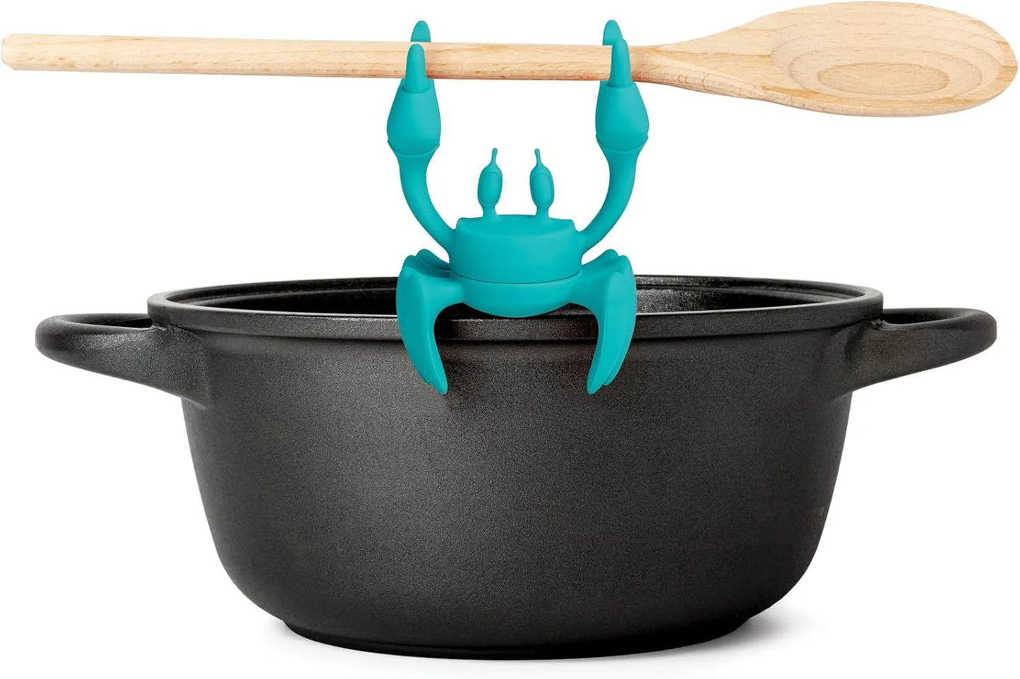 The Aqua kitchen accessory grips a wooden spoon on a pot, serving as a silicone utensil rest.