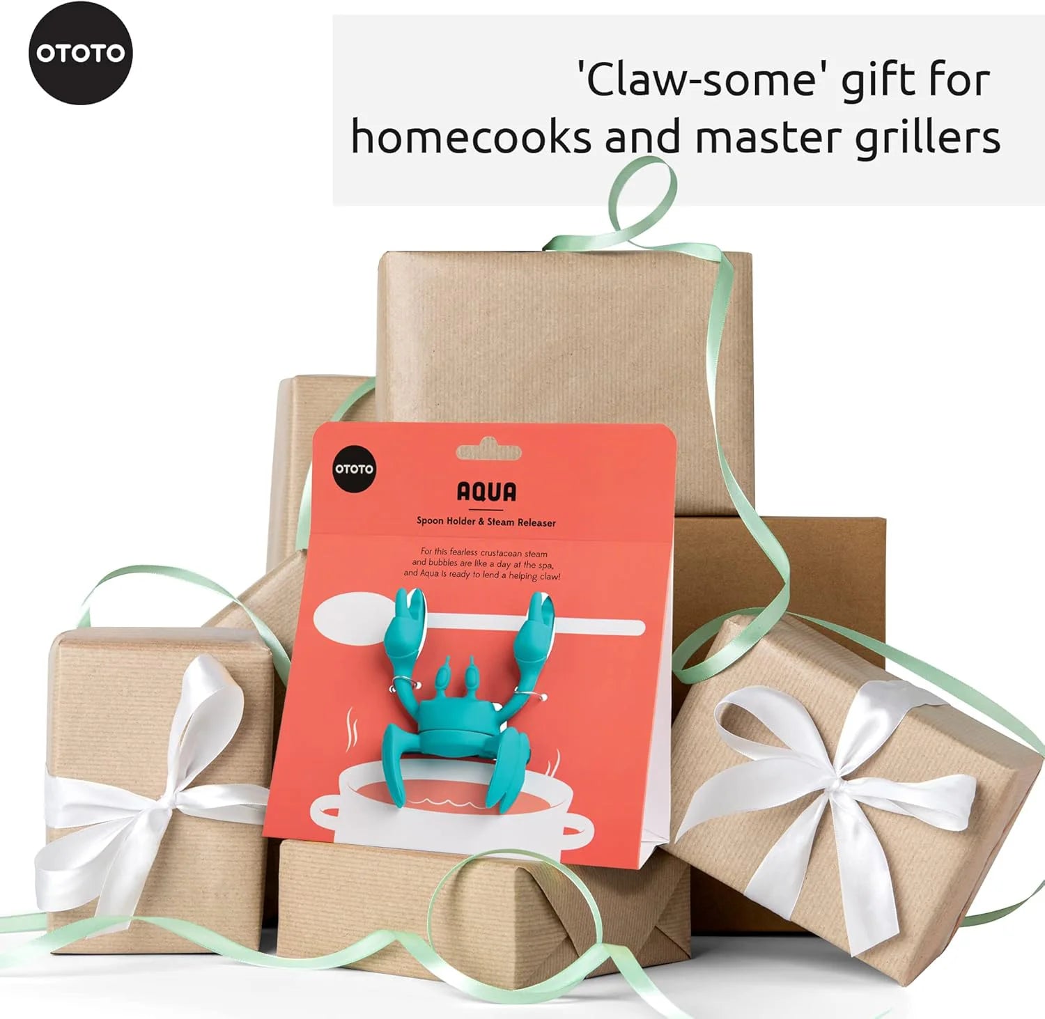 Gift-wrapped boxes with Aqua, the OTOTO crab-shaped utensil rest—a claw-some kitchen accessory!.