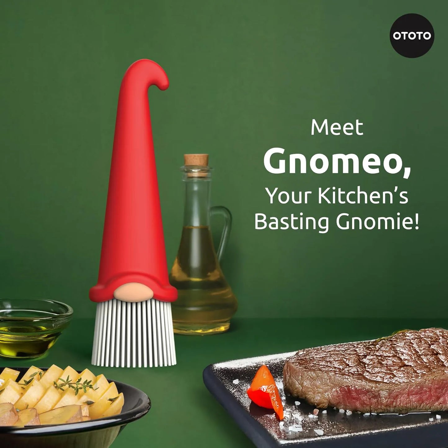 A Gnomeo pastry brush stands by oil, potatoes, and steak on a green background.
