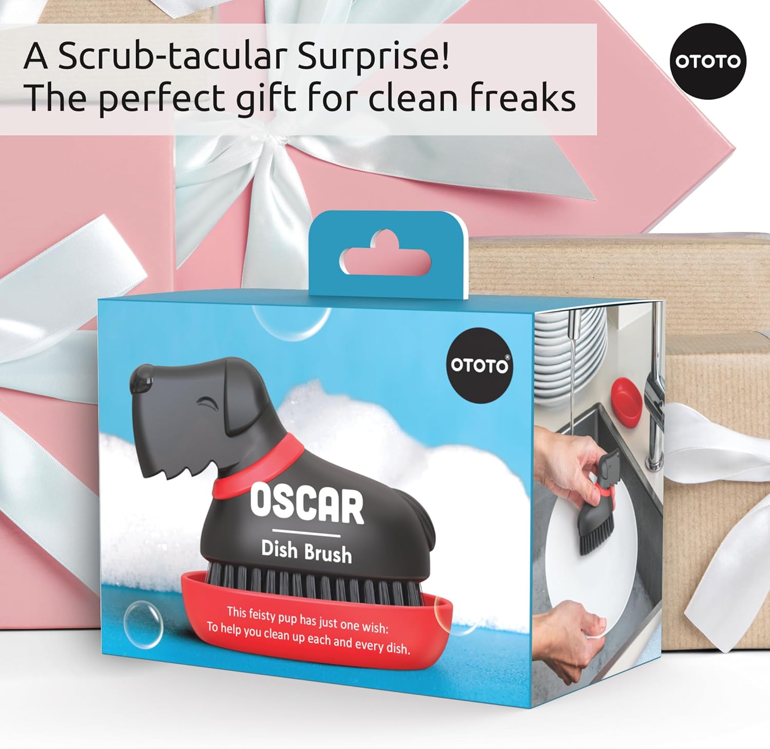 Gift-wrapped box with an Oscar Dish Brush labeled "A Scrub-tacular Surprise!.